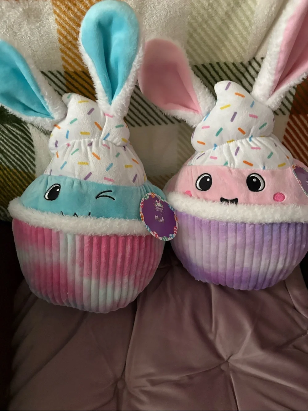 Two Plush cupcakes . 13in height 20 in round , pastel colors , multi / solid